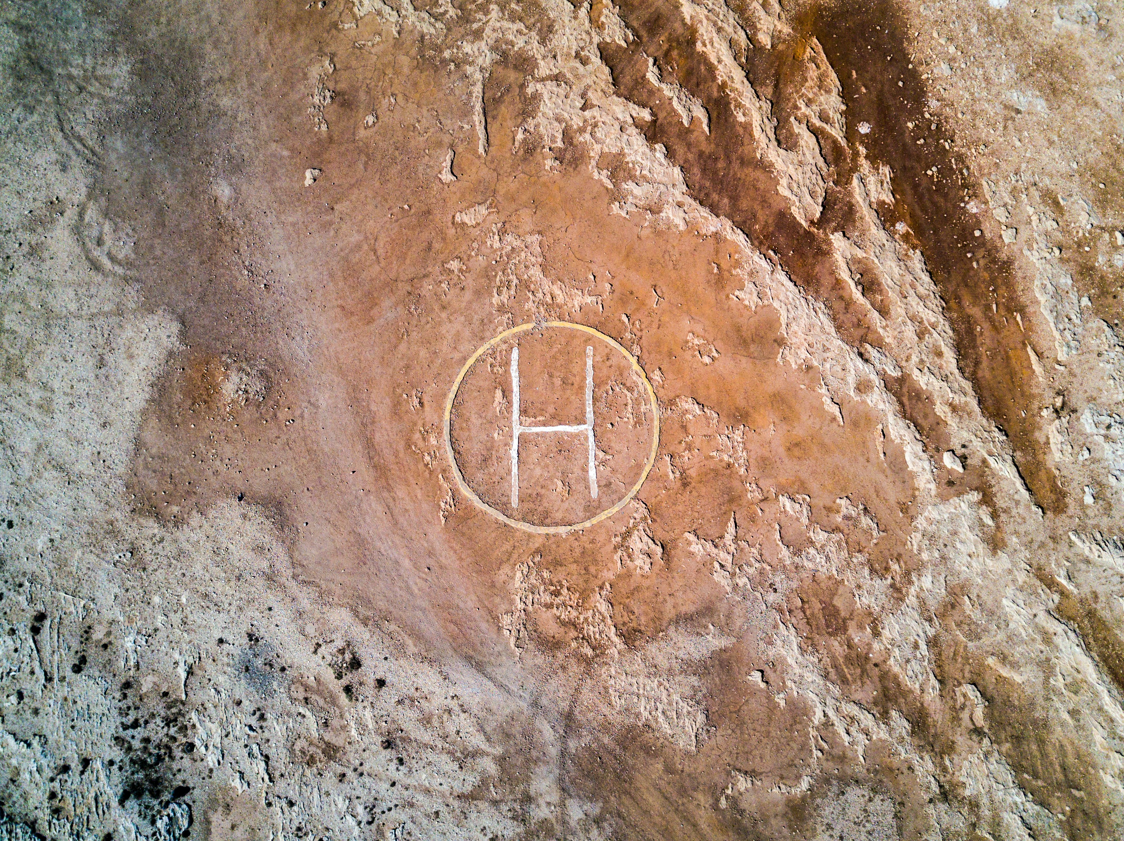 brown rock with helicopter landing area